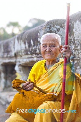 An Unidentified Old Buddhist Female Monk Dressed In Orange Toga Stock Photo An Unidentified Old Buddhist Female Monk Dressed In Orange Toga Stock Photo