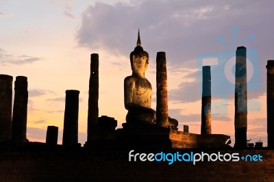 Ancient Buddha Statue At Twilight, Wat Mahathat In Sukhothai His… Stock Photo