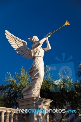 Angel Playing Golden Bugle Stock Photo