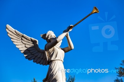 Angel Playing Golden Bugle Stock Photo