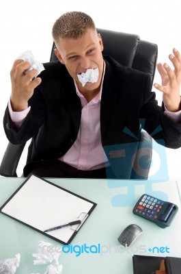 Angry Businessman eating Papers Stock Photo