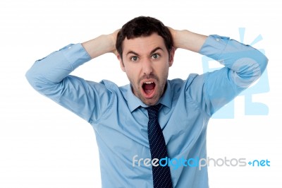 Angry Businessman With Hands On His Head Stock Photo
