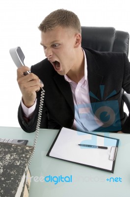 Angry Employee Shouting On Phone Stock Photo