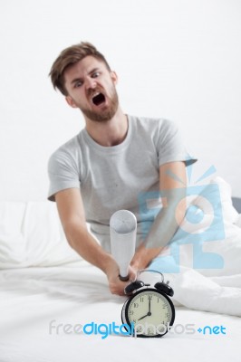 Angry Man Hand Holding Baseball Bat Smashing Alarm Clock Stock Photo