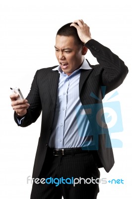 Angry Young Man Using Mobile Stock Photo