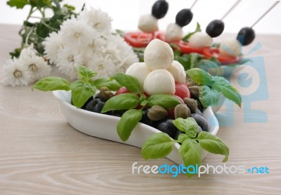 Appetizer Of Mozzarella, Cherry Tomatoes And Olives And Basil Stock Photo