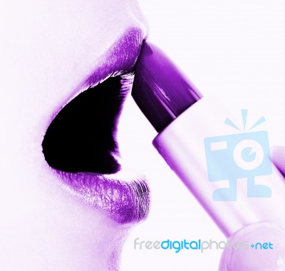 Applying Mauve Or Purple Lipstick Stock Photo