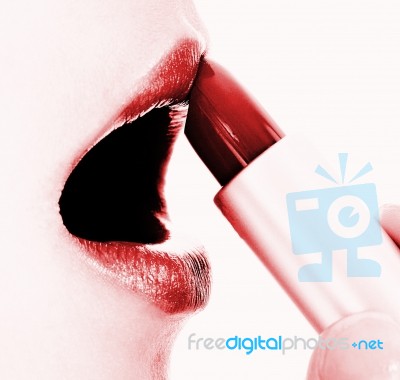 Applying Red Glossy Lipstick Stock Photo