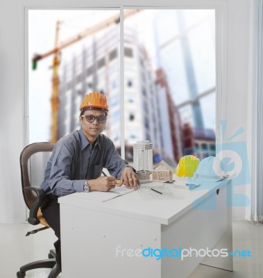 Architect Engineer Working In Office Room Against Building Const… Stock Photo