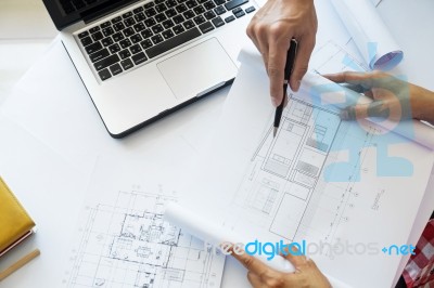 Architects Engineer Discussing At The Table With Blueprint - Clo… Stock Photo