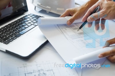 Architects Engineer Discussing At The Table With Blueprint - Clo… Stock Photo