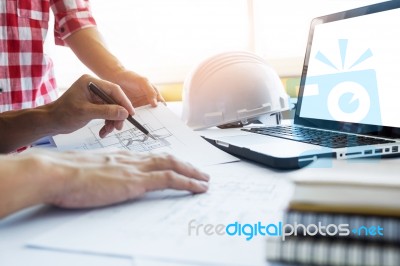 Architects Engineer Discussing At The Table With Blueprint - Clo… Stock Photo