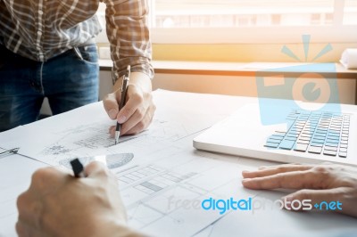 Architects Engineer Discussing At The Table With Blueprint - Clo… Stock Photo