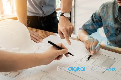 Architects Engineer Discussing At The Table With Blueprint - Clo… Stock Photo