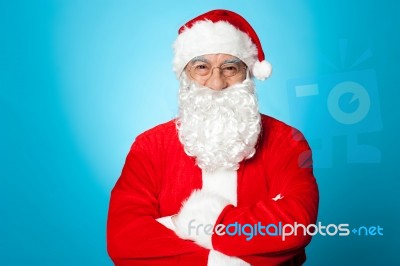 Arms Crossed Santa Claus Over Blue Background Stock Photo