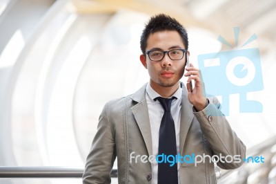 Asia Business Man Using A Mobile Phone Stock Photo