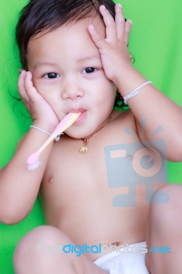 Asian Baby And Toothbrush Stock Photo