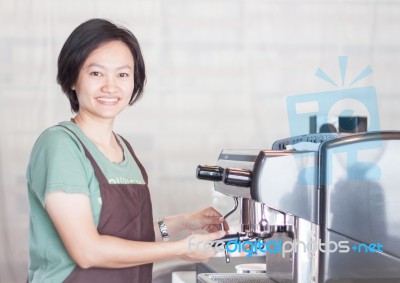 Asian Barista Smiling And Making Cup Of Coffee Stock Photo