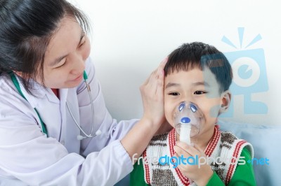Asian Boy Having Respiratory Illness Helped By Health Professional In Hospital Stock Photo
