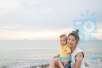 Asian Boy Pose On The Beach With His Mother Stock Photo