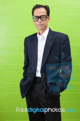 Asian Business Man Wearing Western Suit Standing With Relaxing Emotion Stock Photo