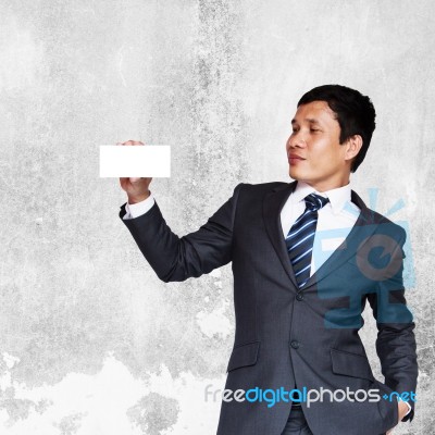 Asian Businessman Showing White Blank Note Stock Photo