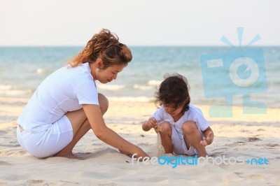 Asian Family Play Sand On Beach Stock Photo