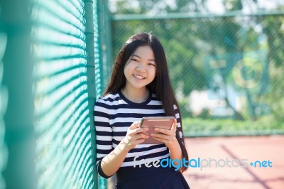 Asian Girl And Computer Tablet In Hand Standing With Toothy Smiling Face Use For People And Internet Connecting ,communication In Modern Digital Lifestyle Stock Photo