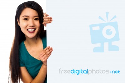 Asian Girl Holding Blank White Ad Board Stock Photo