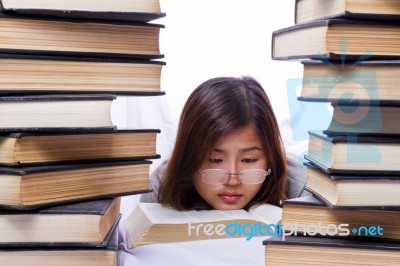 Asian Girl In Pile Of Books Stock Photo