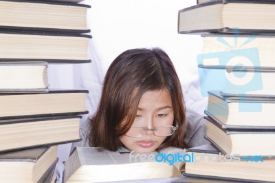 Asian Girl In Pile Of Books Stock Photo