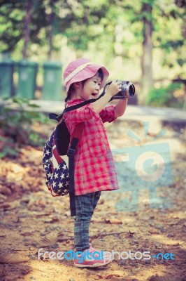 Asian Girl Taking Photos By Digital Camera In Garden. Vintage Effect Tone Stock Photo