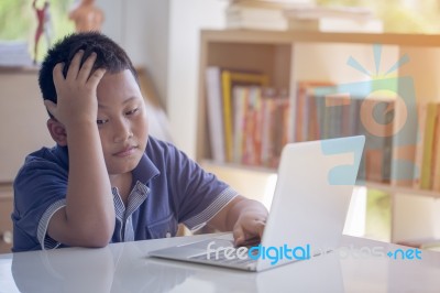 Asian Kid Lose Playing Video Game With Laptop Computer Stock Photo