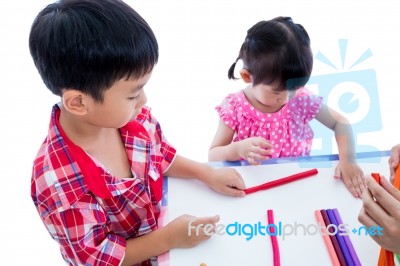Asian Kids Playing With Play Clay On Table. Strengthen The Imagi… Stock Photo
