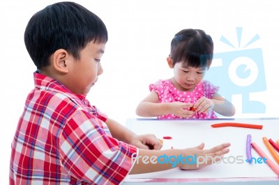 Asian Kids Playing With Play Clay On Table. Strengthen The Imagi… Stock Photo