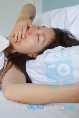 Asian Lying On White Bed Stock Photo
