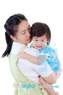 Asian Mother Carrying And Soothe Her Daughter On White Background Stock Photo