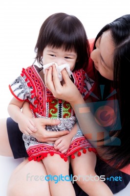 Asian Mother Wipes Snot Her Daughter On White Background Stock Photo