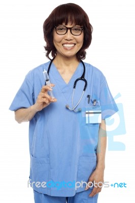 Asian Surgeon Holding Injection Stock Photo