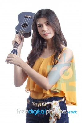 Asian Woman Holding Angry Ukulele In Hand Stock Photo