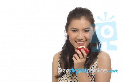 Asian Woman Is Eating An Apple Stock Photo