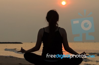 Asian Woman Practicing Yoga At Peace Sea In Morning Stock Photo