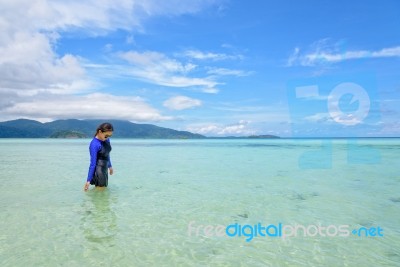 Asian Woman Walking In The Sea At Travel To Koh Lipe Island Stock Photo