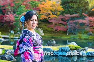 Asian Woman Wearing Japanese Traditional Kimono In Autumn Park. Japan Stock Photo