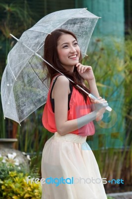 Asian Woman With A Transparent Umbrella Stock Photo