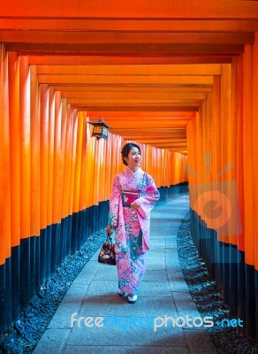 Asian Women In Traditional Japanese Kimonos At Fushimi Inari Shrine In Kyoto, Japan Stock Photo