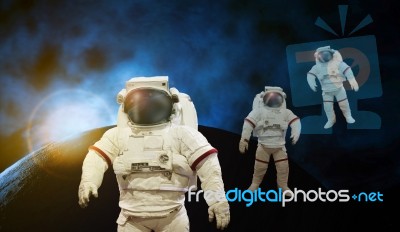 Astronaut Working On Space With Sun Light With Earth And Cosmos Background Stock Photo