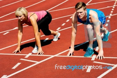 Athletes At Starting Line On Race Track Stock Photo