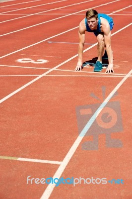 Athletic Man On Track, All Set For Race Stock Photo