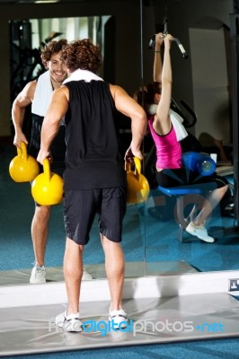 Athletic People Working Out With Equipments Stock Photo